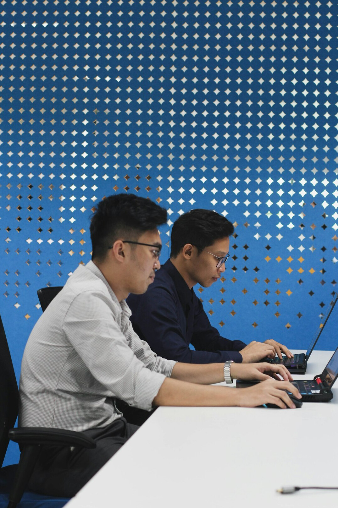 students coding on laptops